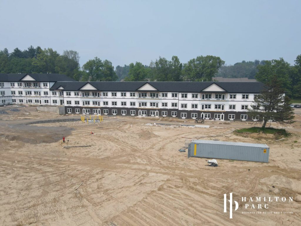 Building showing residences as well as future front fountain area under construction, June 2023